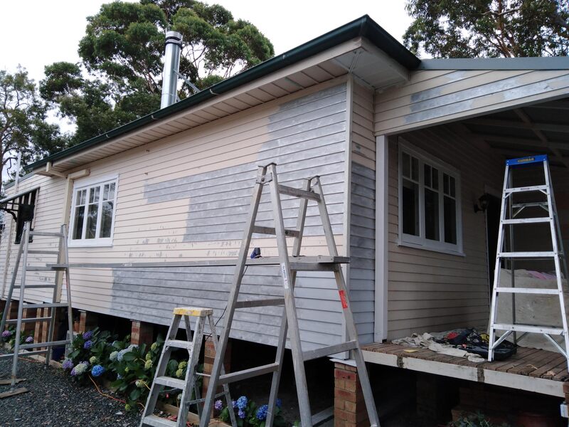 Paint being stripped from exterior wall of a house at Lake Munmorah.